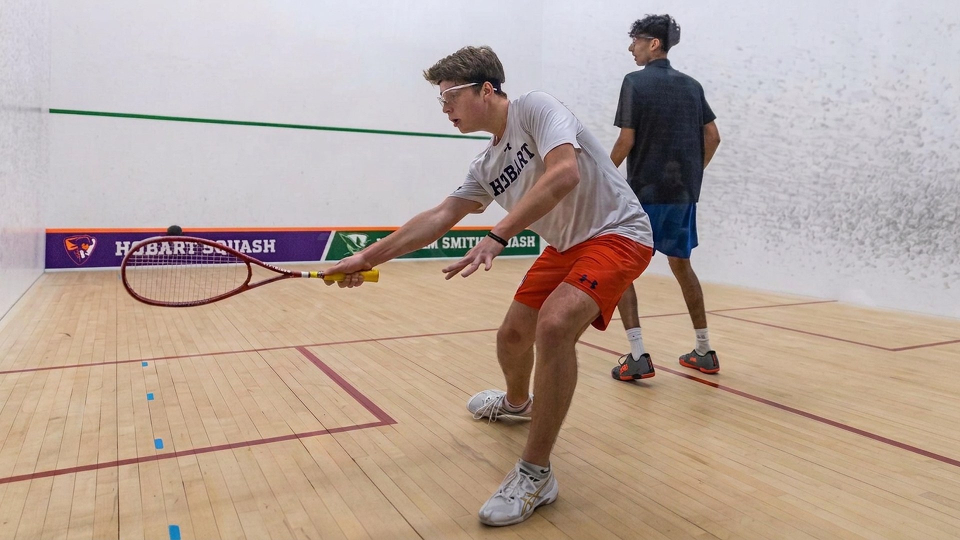 Squash players in action at Cross Court Squash